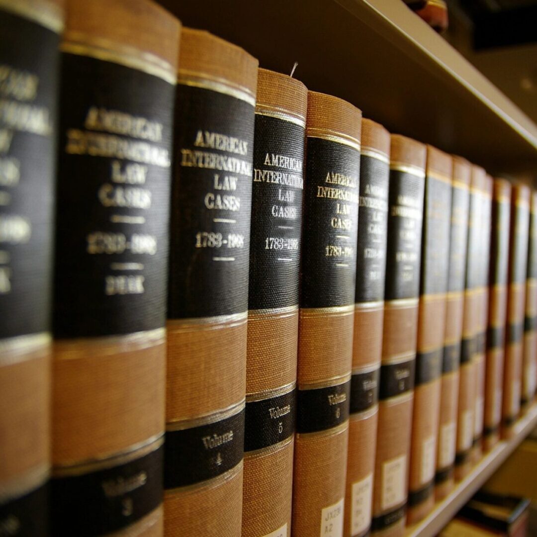 Row of legal books neatly arranged on a shelf.
